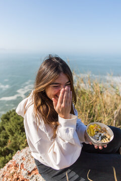 Woman Enjoying Healthy Meal with Scenic Ocean View