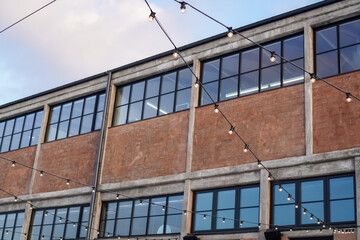 Historic Noblessner building in Tallinn illuminated by string lights in 2024