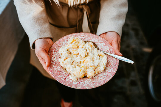 plate of creamy potato is served on decorative pink dishware.