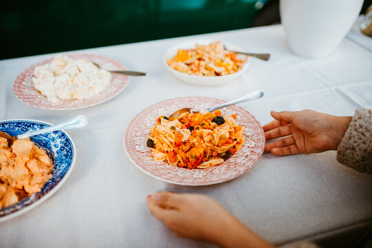 table set with colorful pasta salad offerings for sharing.