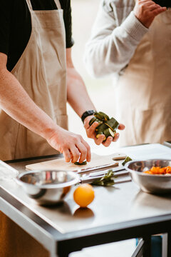 cooking class: chefs chopping vegetables with expertise, focus.