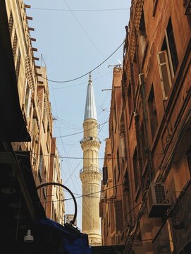 A minaret rises through buildings