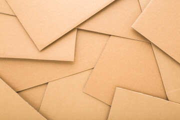 Heap of new light brown carton background. Closeup. Top down view.