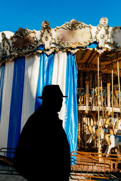 An elderly man on the background of a classic carousel