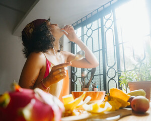 Woman Drinking Smoothie in Bright Kitchen
