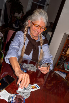 Happy woman playing cards