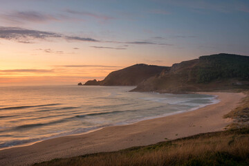 Sunset on the beach of Mar de Fora, Finisterre, Galicia, Spain. This beach is the westernmost beach in Europe, so people go there to see one of the most impressive sunsets in Northern Spain