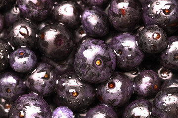 Wet acai berries as background, closeup view