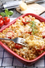 Delicious al forno pasta in baking dish on table, closeup