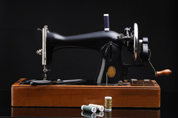 Vintage professional sewing machine on black background