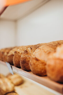 Freshly Baked Artisan Breads Lined Up in a Cozy Bakery Setting