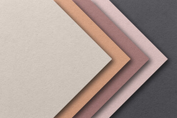 From above layout of colorful cardboard sheets in brown, grey and blue shades .  