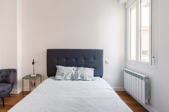 A minimalist bedroom with a neatly made bed