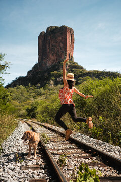 woman jumping with arms outstretched in bautiful landscape