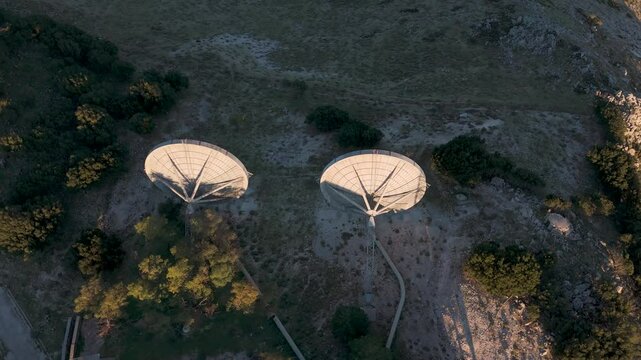 Satellite dishes rotating in remote mountain location