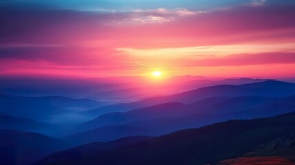 Obraz premium A stunning sunset view from a mountaintop, with vibrant colors painted across the sky and valleys below.