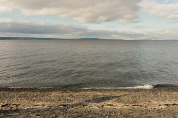 looking at the tide coming in on cloudy day at Carkeek Park, Seattle, WA