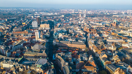 Strasbourg, the capital of Christmas, sparkles during Advent, with its stunning decorations and festive ambiance. This aerial view features the majestic Strasbourg Cathedral, La Petite France 