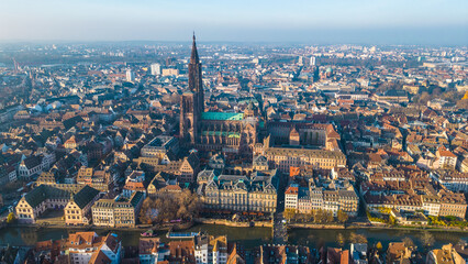 Strasbourg, the capital of Christmas, sparkles during Advent, with its stunning decorations and festive ambiance. This aerial view features the majestic Strasbourg Cathedral, La Petite France 