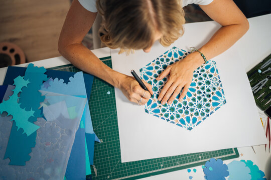 Artist designing geometric islamic pattern for cutting