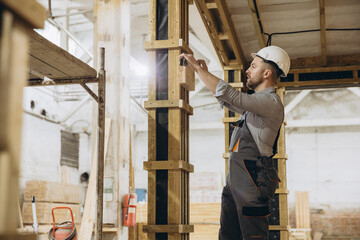 Construction worker building modular house wooden structure