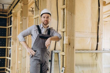 Construction worker posing in modular building under construction