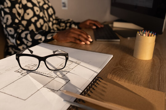 Unrecognizable architect working on computer 