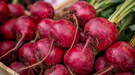A wooden box filled with lots of red beets