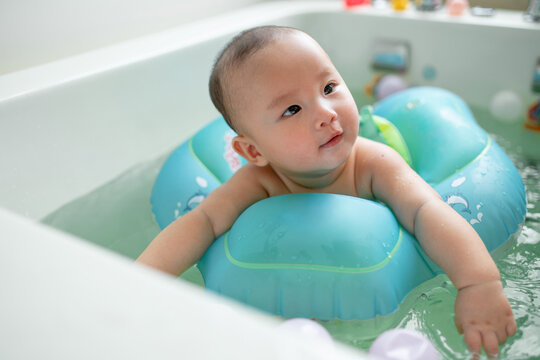 Adorable Baby Enjoying Bathtub Time with Float Ring