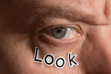 Close-Up of Human Eye With the Word Look Beneath It