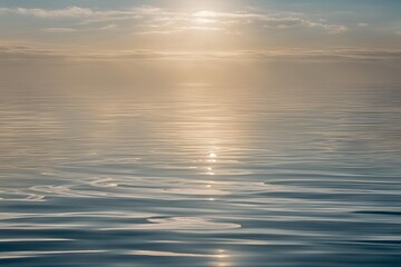 Obraz premium A close-up of the surface of seawater, with gentle ripples creating a dynamic texture. The water is clear, with soft reflections of sunlight shimmering across the surface.
