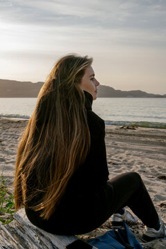 A Young Woman Gazes Thoughtfully at the Serene Barents Sea