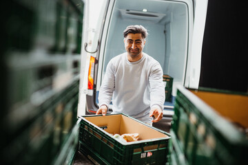 Happy delivery guy picking up groceries 