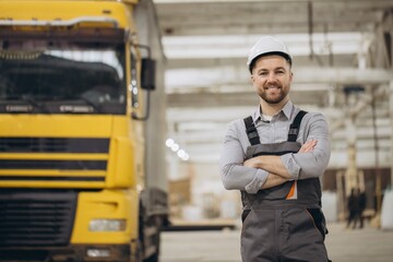 Engineer smiling with crossed arms in modular building factory
