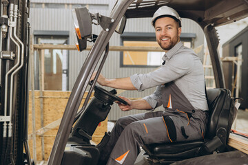 Construction worker driving forklift in modular building industry