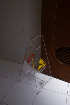 Clear Caution Sign on Tiled Floor