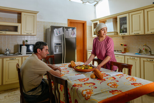 Moroccan woman brings to the table the traditional Tajine
