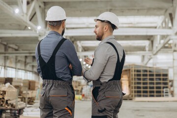 Engineers discussing prefabricated modular building construction in factory