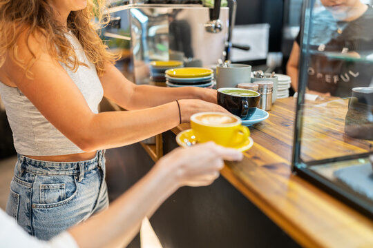 Barista preparing coffee drinks in coffee shop