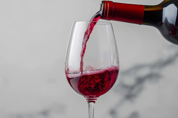Red wine, pouring from a bottle into a glass, on a transparent background. A file with a clipping, white background. for advertising.