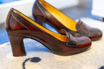 Red women's pumps on a patty in front of a window