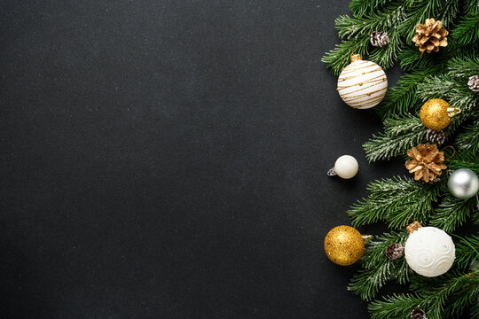 Christmas decorations and spruce tree at black background. Flat lay with copy space. - Powered by Adobe
