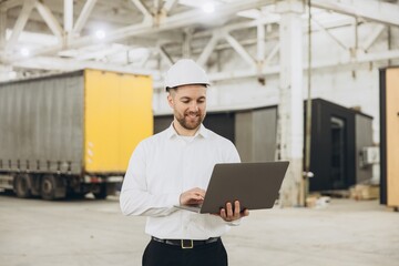 Engineer using laptop in modular building factory