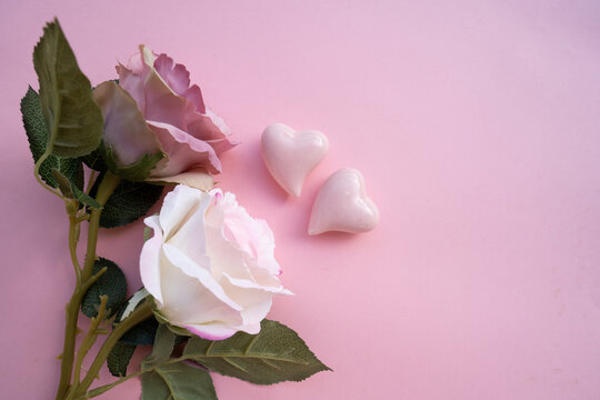 Valentines day background with two hearts over pink background with shadow overlay