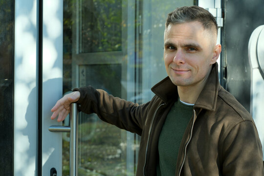 Confident man enjoying a sunny day outside a modern building in the city