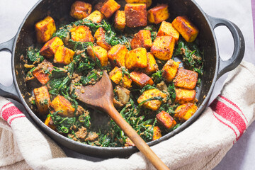 Saag paneer. Fried paneer cheese with turmeric, onion, garlic and spinach 