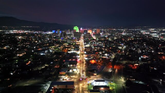Reno Nevada - Downtown Reno and Midtown Aerial Approach at Night over Cars 