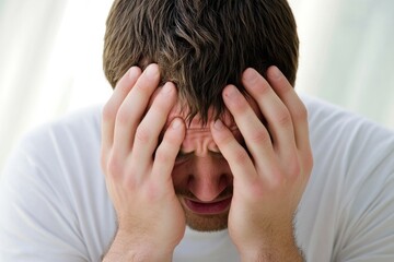 Fototapeta premium Sorrowful Man Hiding Tears with Head in Hands, Capturing the Essence of Loneliness and Disappointment
