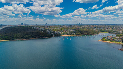 Aerial View of Manly Beach and Sydney harbour with manly houses on a warm summer day blue skies Sydney NSW Australia