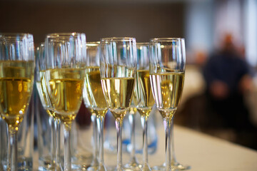 Celebration with champagne glasses arranged elegantly on a table at a gathering. Photo. Selective focus. Close-up